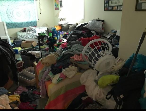 Concord CA home in need of hoarding services with clothing covering the floor