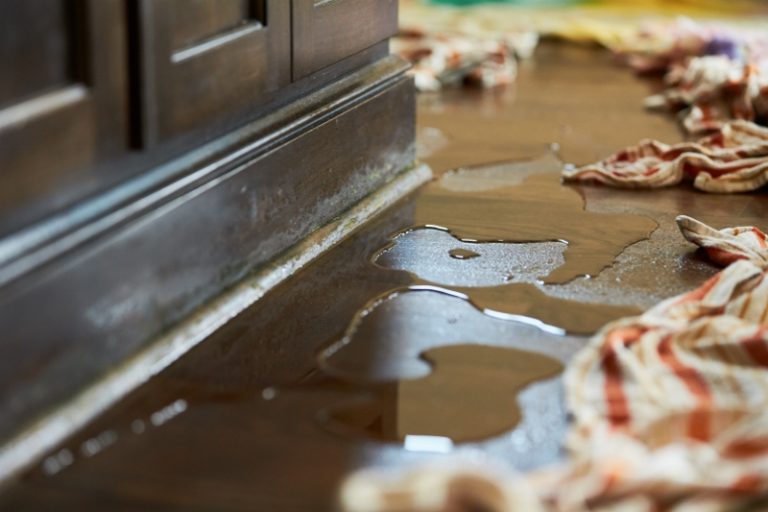 Water and towels on the floor of a home after flooding