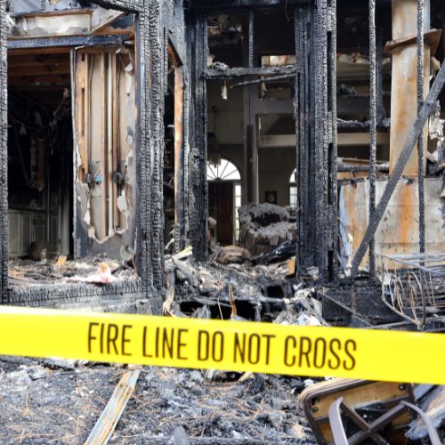 A fire-damaged building in Flushing, Michigan with “Fire Line Do Not Cross” tape in front of it