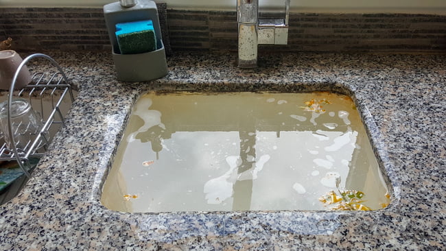 sewage backup about to cause flooding in kitchen sink