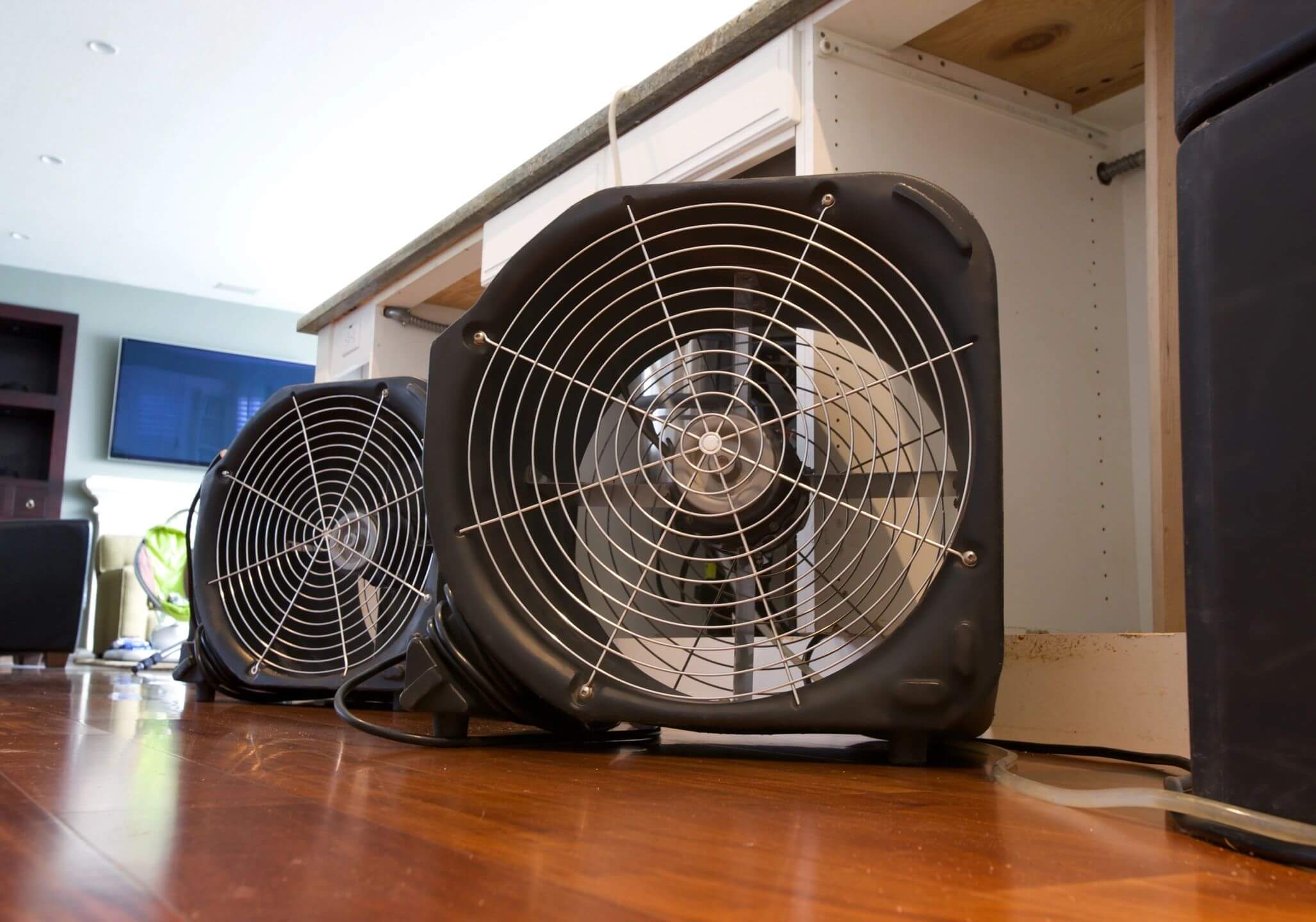 industrial fans drying out water damage inside a home