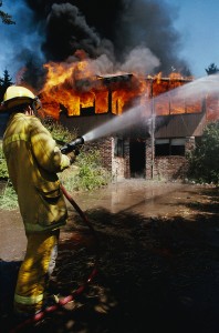 fireman putting out fire with hose