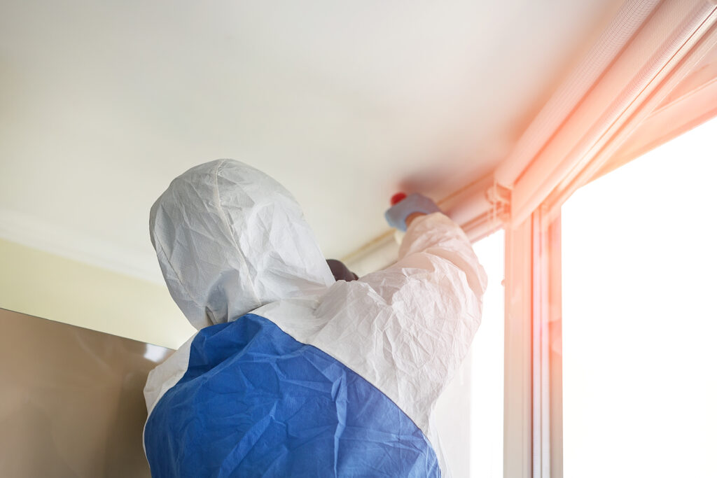 A ServiceMaster technician disinfecting a space during odor removal in Des Plaines, Illinois