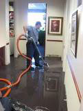 man cleaning up the water damage