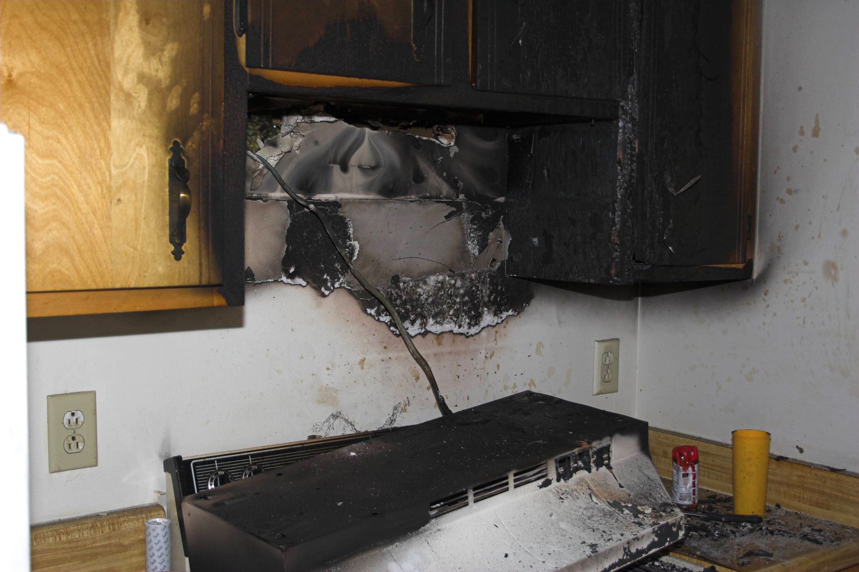 A severely fire damaged stovetop and range hood in a kitchen in Hampstead, NC
