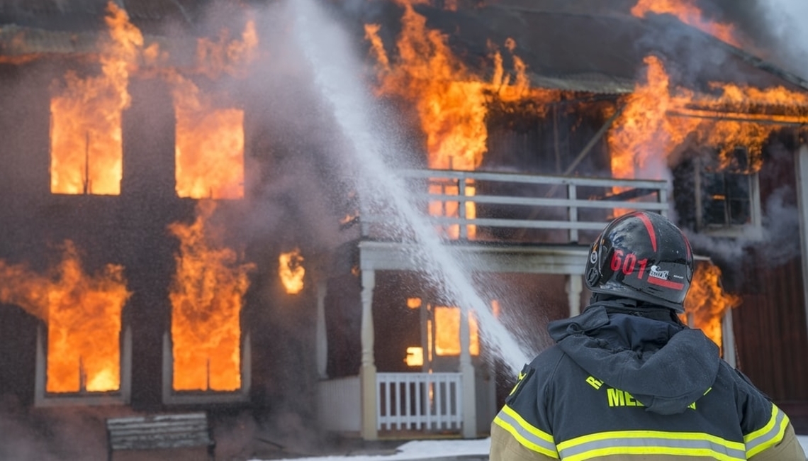 Firefighter Putting Building Fire Out