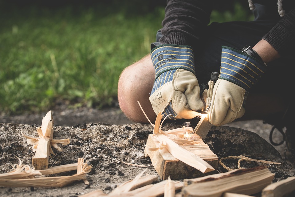 A person starting a campfire