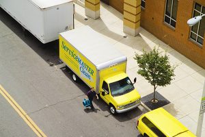 Man walking next to a yellow ServiceMaster truck