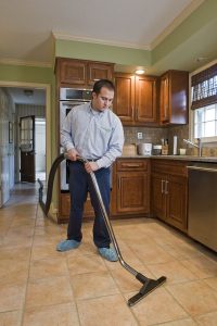 Man cleaning a tile floor