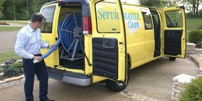 Man Pulling Hose out of a ServiceMaster Van