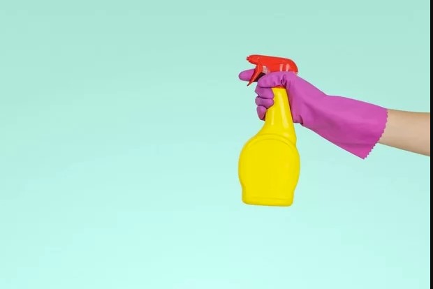 woman holding spray bottle