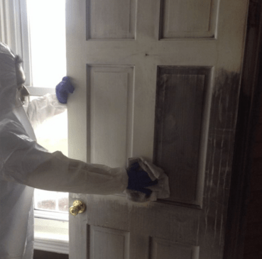 Tech cleaning a door