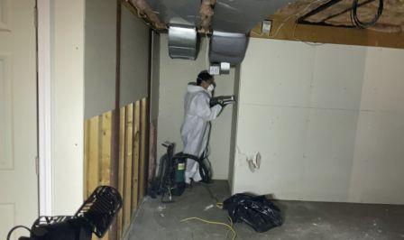 water damage restoration technician performing demo