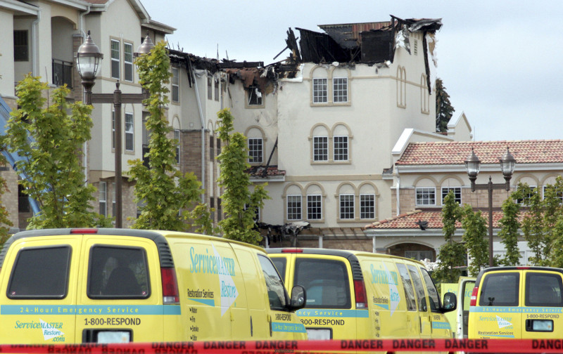 ServiceMaster vans outside of fire damage 