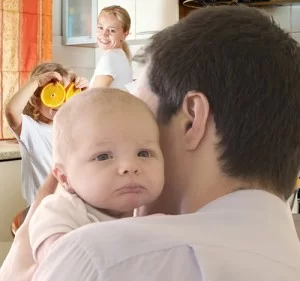 father holding newborn baby