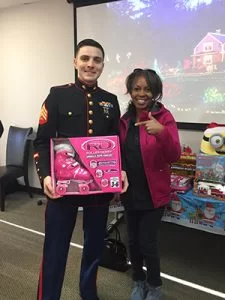 Dianne with the US Marine representative as she makes her donation