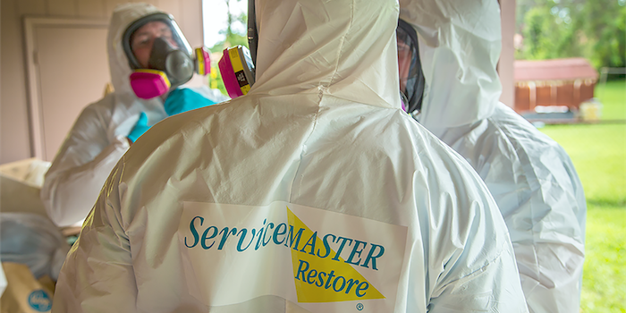 servicemaster restore technicians in hazmat suits