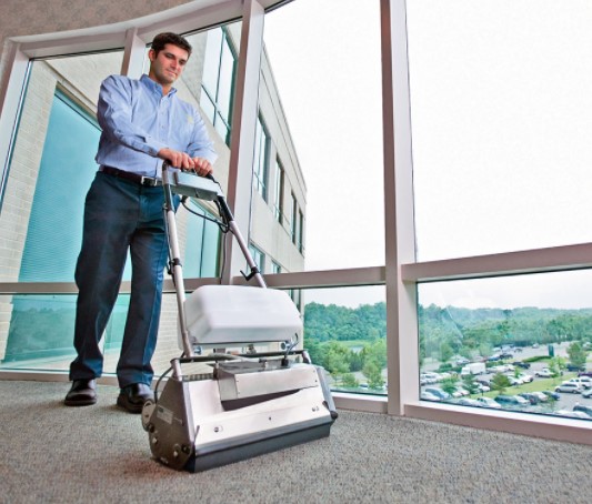 Man Using Machine to clean carpet