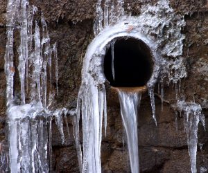 outdoor frozen pipe with icicles 