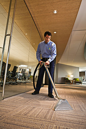 Man vacuuming a floor