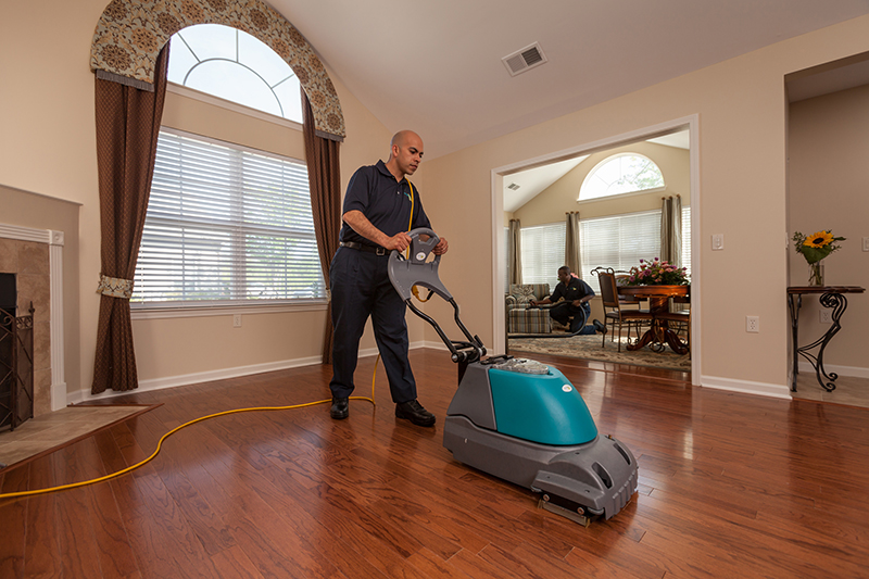 A ServiceMaster technician using a specialized machine on a floor during floor cleaning services in Sioux City