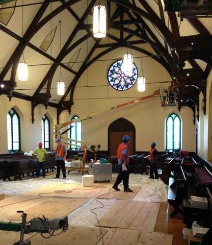 workers doing construction inside a church