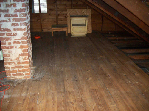 clean attic with wood flooring 