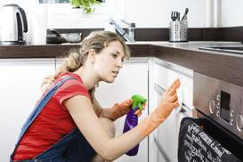 Woman Wiping A Kitchen Drawer