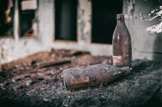 Glass Bottles Amongst Soot and Char Debris