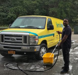 man washing a yellow van