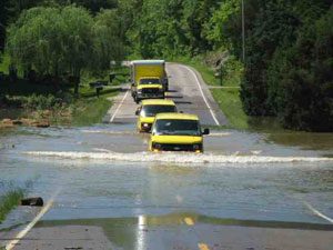 Cars passing by flood waters