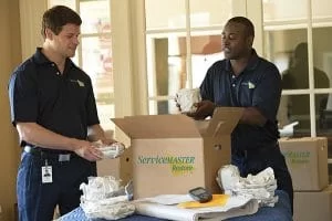 two service master professionals unpacking a box