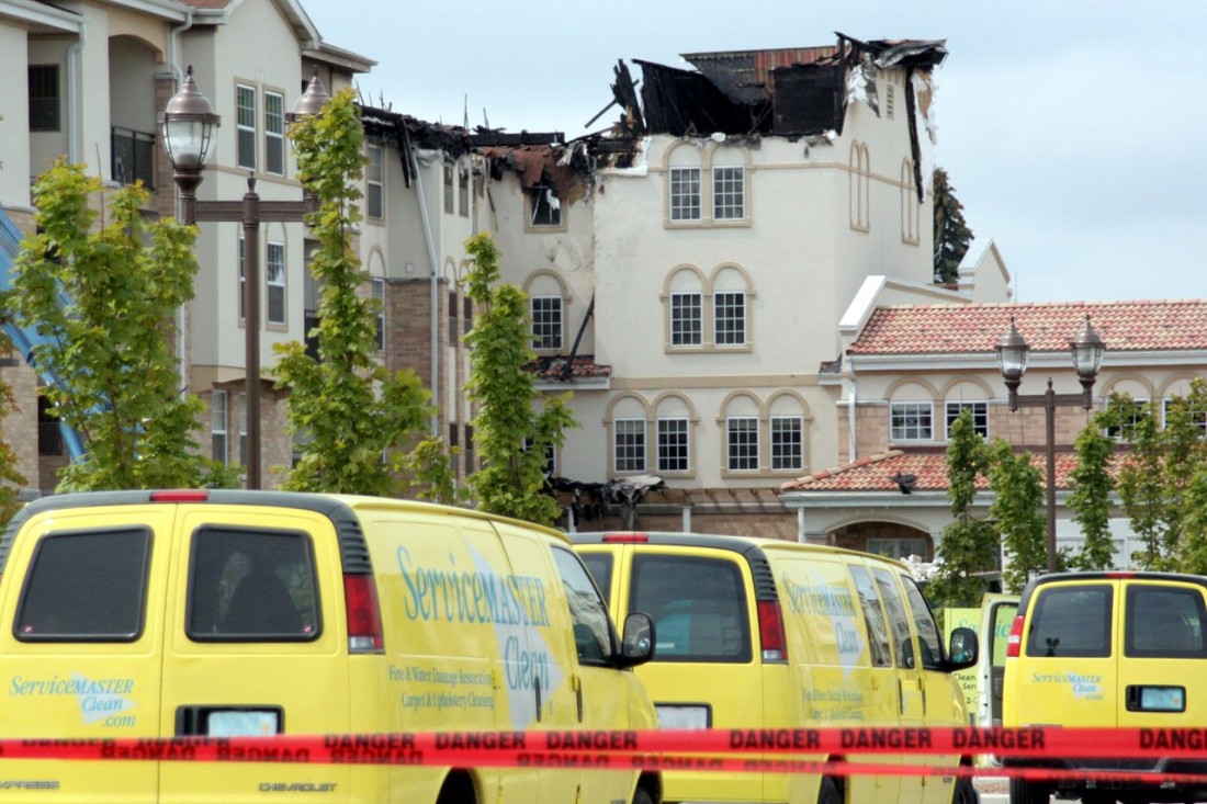 Damaged Commercial Building with ServiceMaster Vans in Front