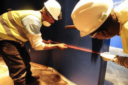 Two men chalking a wall