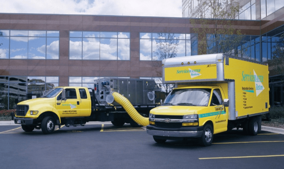 ServiceMaster trucks in front of a commercial building