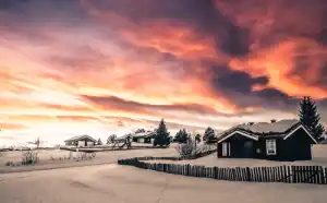House Yard Covered in Snow and Sunset