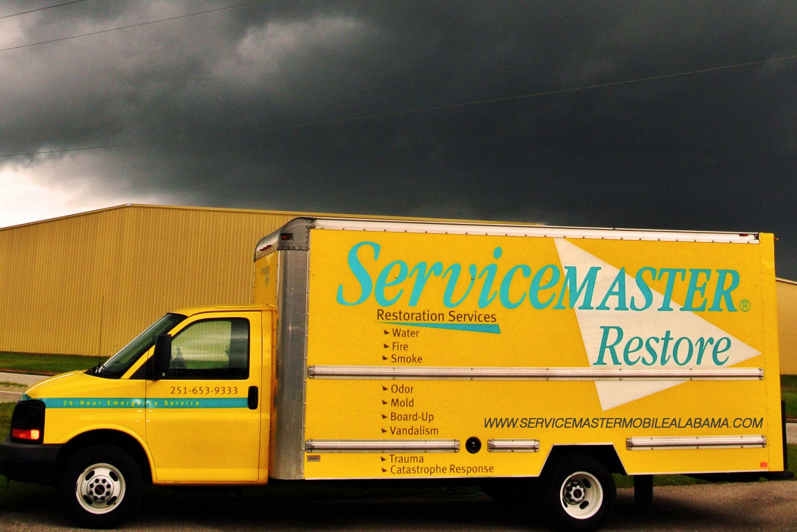 Yellow ServiceMaster Restore truck out during unfavorable weather