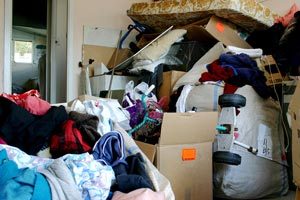 Clothing, boxes and other items piled on top of each other