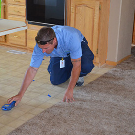 technician looking for water damage on floor