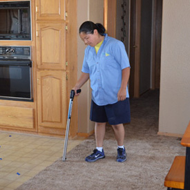 technician looking for water damage on carpet